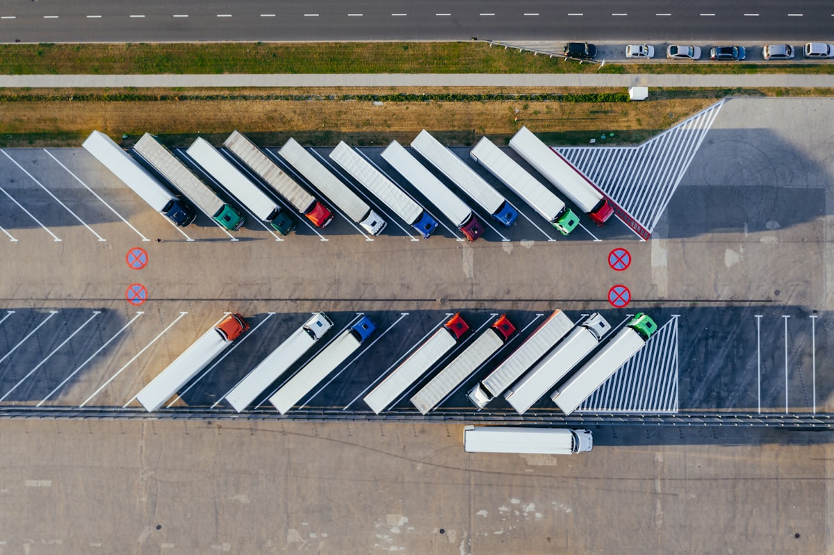 Aerial view of a logistics depot with cargo trucks, representing industrial supply chains