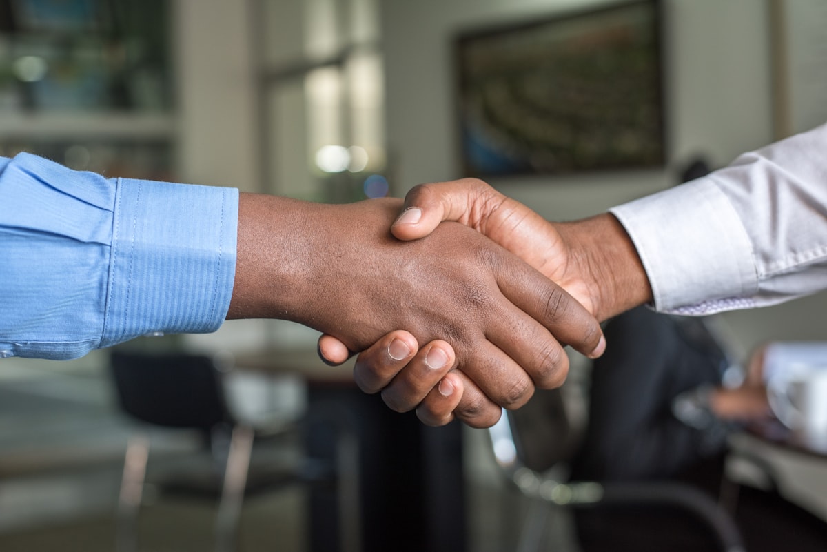 International business partners shaking hands at a strategic collaboration meeting